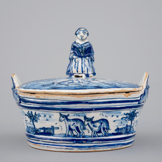 A blue and white Dutch Delftware butter tub with a lady-shaped finial, 18th C.